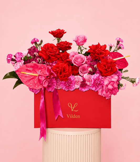 Amore Vivace luxury flower box with red roses, pink roses, carnations, and pink anthuriums in a bold red Vilden box