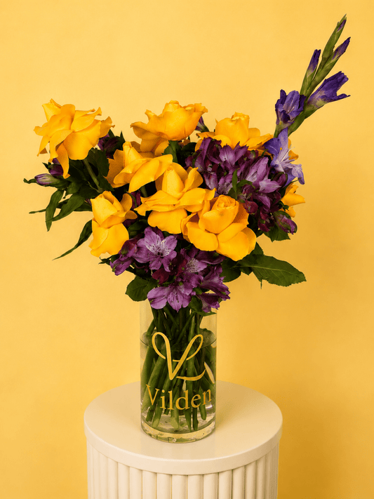 Sunlit Royale, a golden and violet flower arrangement bouquet featuring yellow roses, purple gladiolus arranged in a vase