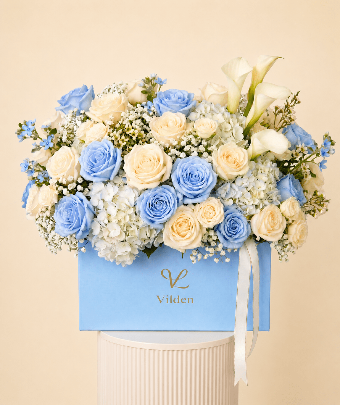 Elegant Serenade in Blue bouquet exudes tranquility with soft blue roses, cream hydrangea, and delicate baby's breath.