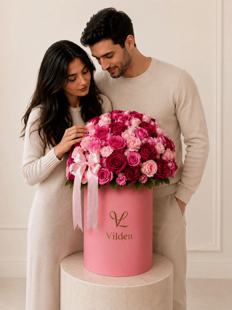 Blush Crescendo pink rose arrangement in a Vilden box with a natural-looking couple
