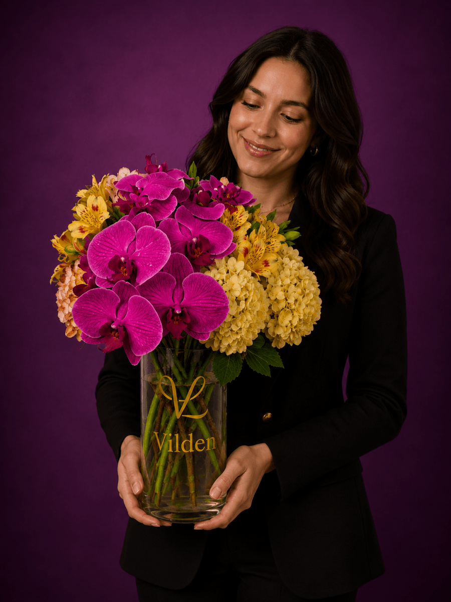 Purple orchid and yellow hydrangea, golden blooms arrangement in the Vilden vase with a model a the Vilden studio