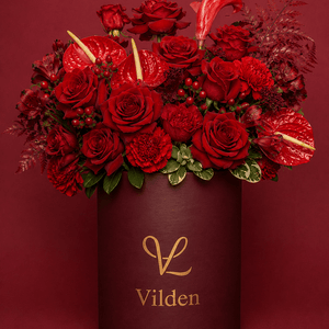 Sultry and luxurious Velvet Ember featuring intense, rich reds for deep, quiet love. Handcrafted with premium blooms.