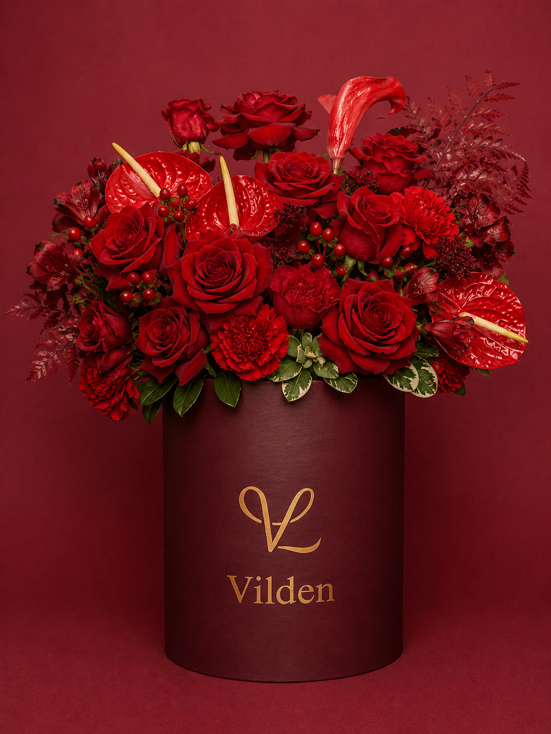 Sultry and luxurious Velvet Ember featuring intense, rich reds for deep, quiet love. Handcrafted with premium blooms.