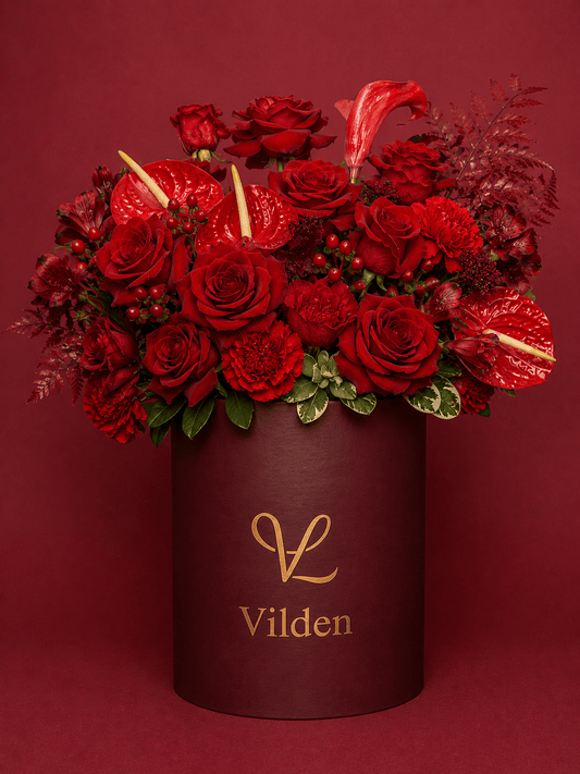 Sultry and luxurious Velvet Ember featuring intense, rich reds for deep, quiet love. Handcrafted with premium blooms.